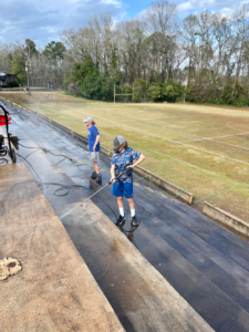 boy pressure washing steps