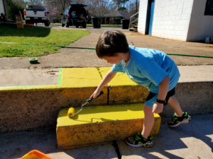 young boy repainting steps